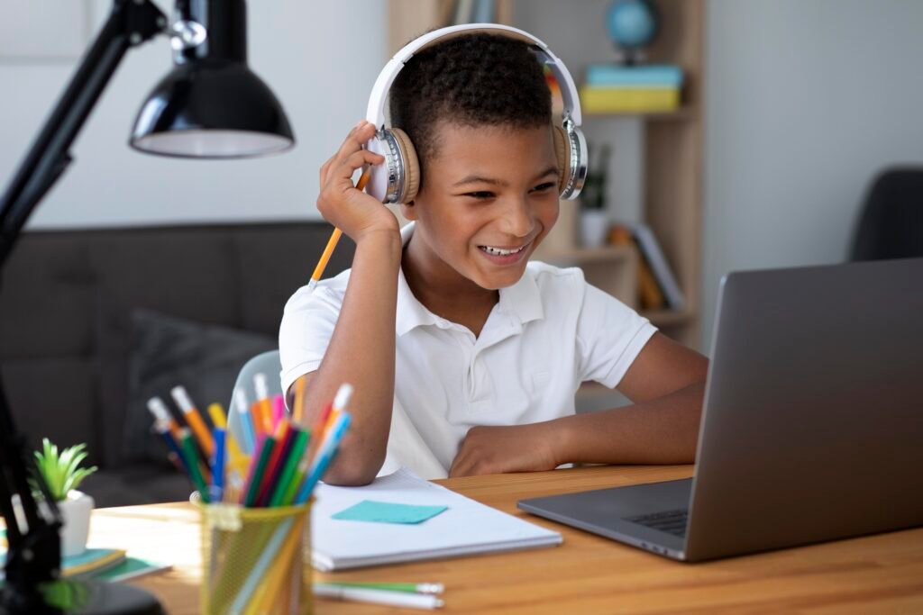 little boy doing school online