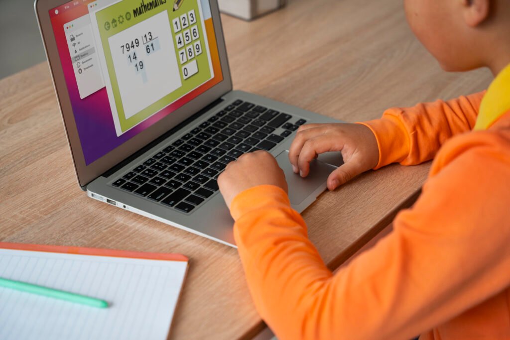 little boy watching films laptop